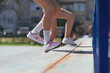 © qunica.com - Girls exercising legs. Girls doing jumps on bench. Close up shot