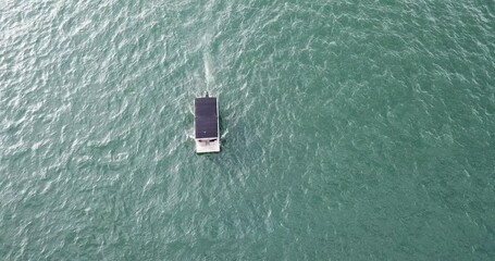 Wall Mural - Bird eye view of a white motorboat moving in the shiny sea water