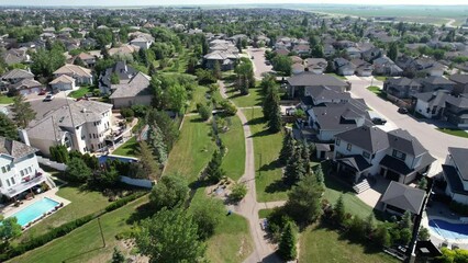 Wall Mural - Aerial footage over urban houses with trees and streets in Saskatoon, Canada