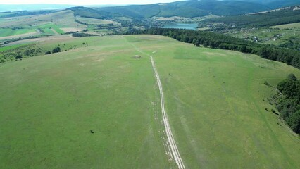 Poster - Drone shot around Big cellar monument with green landscape of hills, Hungary