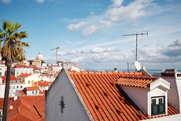 Sticker - Beutiful view of old town in Lisbon. Red tiled roofs and blue sky.