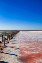 Rose Color Water Against A Layer Of Salt On A Salt Lake