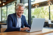 Happy Mature Business Man Looking At Laptop Computer
