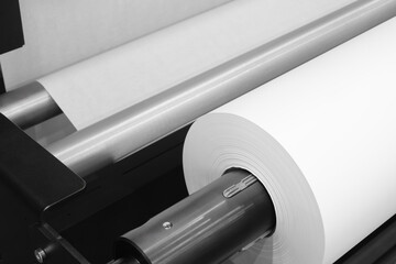 Rolls paper and fabric in wide industrial plotter