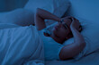 © Prostock-studio - Sleeping Problem. Stressed african american woman lying in bed and touching head