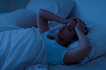 Sleeping Problem. Stressed african american woman lying in bed and touching head