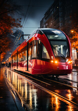 Red And Black Shiny Tram On The Street. City Public Transport Working On Rainy Day In The Evening.