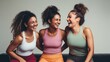 © Adriana - Fun in fitness clothing: Three female friends laughing happily in a sports studio