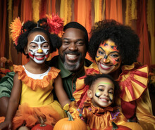 Portrait Of Black Family Dressed In Halloween Costumes. Parents With Two Daughters Are Smiling And Looking At The Camera.
