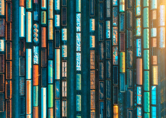 Wall Mural - aerial view of freight trains at sunset. railway cargo wagons with goods on railroad. top view of co