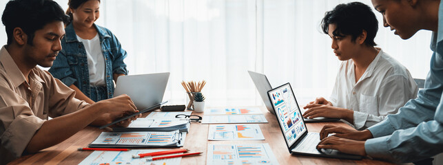 Leinwandbilder - Panorama shot analyst team utilizing BI Fintech to analyze financial report with laptop. Businesspeople analyzing BI power dashboard displayed on laptop screen for business insight. Scrutinize