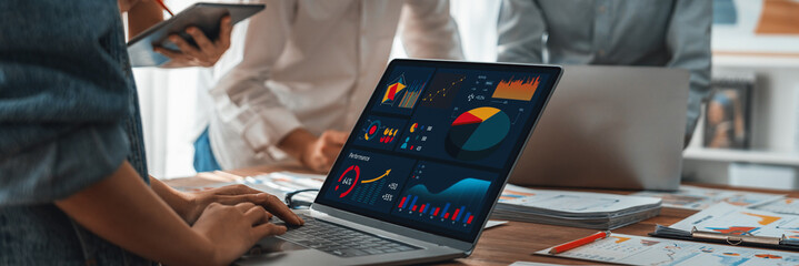 Leinwandbilder - Panorama shot analyst team utilizing BI Fintech to analyze financial report with laptop. Businesspeople analyzing BI power dashboard displayed on laptop screen for business insight. Scrutinize