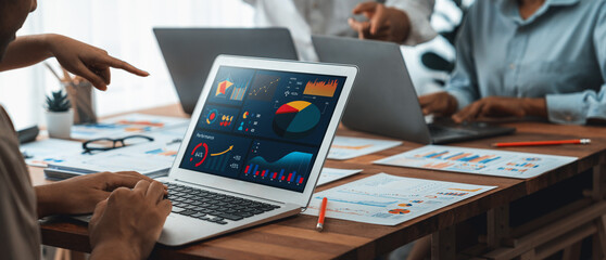 Leinwandbilder - Panorama shot analyst team utilizing BI Fintech to analyze financial report with laptop. Businesspeople analyzing BI power dashboard displayed on laptop screen for business insight. Scrutinize