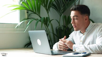 Wall Mural - Concentrated skilled millennial caucasian businessman in glasses wearing headphones with mic, taking part in online web camera negotiations meeting using computer app, distant communication concept.
