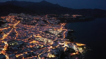 Wall Mural - Scenic view from drone of spanish town of Nerja on southern Mediterranean coast at night, Malaga, Spain