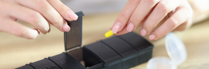 Sticker - Woman puts medical pills for treatment of diseases in box with sections.