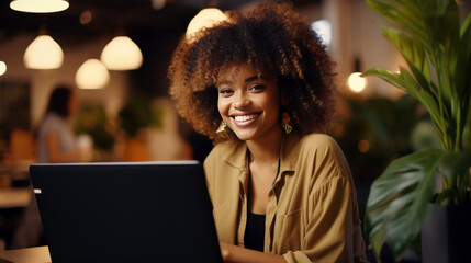 Wall Mural - business woman looking , smiling in camera. Woman sitting in coffee shop and working with laptop.