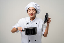 Young Beautiful Asian Woman Chef In Uniform Holding Soup Pot Ladle Utensils Cooking In The Kitchen Various Gesture Menu Good Taste On Isolated. Cooking Woman Chef People In Kitchen Restaurant