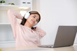 © mangpor2004 - Young asian woman with headphones stretching for relax after working