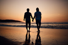 Silhouette, Holding Hands And Gay Men On Beach, Sunset And Shadow On Summer Vacation Together In Thailand. Sunshine, Ocean And Romance, Lgbt Couple In Nature And Fun Holiday With Pride, Sea And Sand.