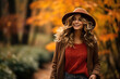 © fotogurme - Woman walking through a colorful autumn park in a cozy sweater