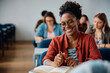 © Drazen - Happy black females student during class in lecture hall looking at camera.