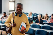 © Drazen - Portrait of smiling senior student in classroom looking at camera.