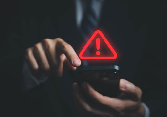 Wall Mural - businessman using laptop showing warning triangle and exclamation sign icon warning of dangerous pro