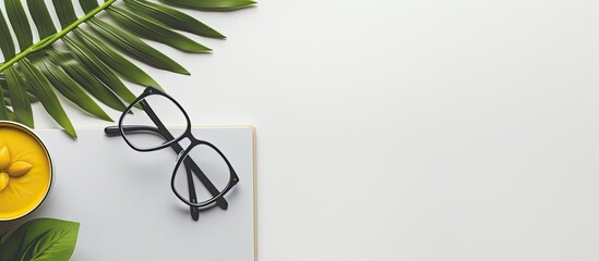 Leinwandbilder - a plant, a keyboard, a computer mouse, glasses, a yellow notebook, and a pencil. They are all placed on a grey background with empty space around them.