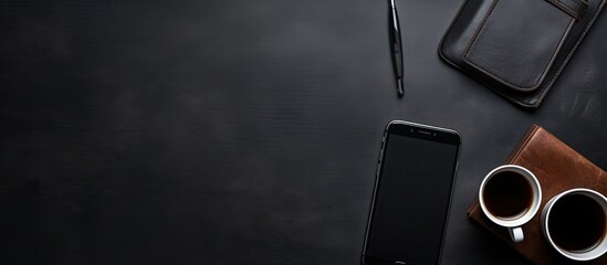 Poster - modern workplace in a company, featuring a cellphone, espresso, leather planner, and pen, all set on a black backdrop with blank space.
