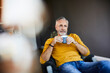 © Westend61 - Relaxed mature man at home with cup of coffee