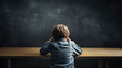 © Studio Nova - Struggling schoolboy holding his head while sitting in school class against the backdrop of the blackboard. Created with Generative AI technology.