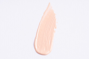 Sticker - A smear of foundation cream or concealer on a white background, macro. Texture of cosmetic liquid foundation or beige cream smudge, smear, stroke. Advertising of professional cosmetics..