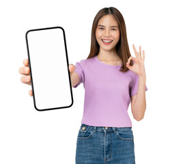 Wall Mural - Cheerful beautiful Asian woman holding big smartphone and shows ok sign on grey background.