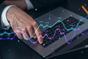 Wall Mural - Woman typing on laptop at office workplace in background. Concept of working process, internet surfing, online business education. Student send e-mail. Close up view. Hands Shot. Stock market chart