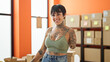 © Krakenimages.com - Hispanic woman with amputee arm ecommerce business worker smiling confident standing at office