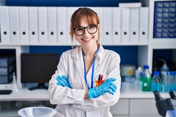 Poster - Young woman scientist smiling confident standing with arms crossed gesture at laboratory