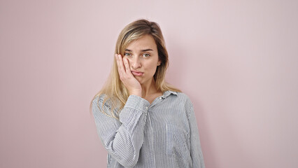 Poster - Young blonde woman standing with boring expression over isolated pink background