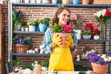 Sticker - Young beautiful hispanic woman florist holding plant at florist