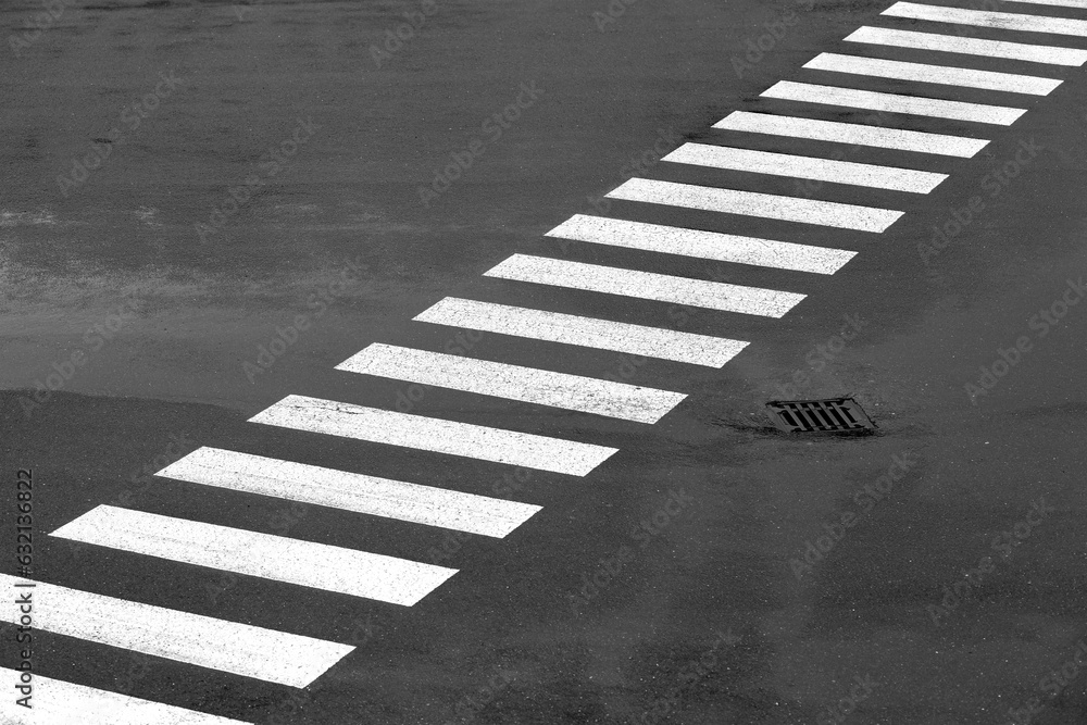 Diagonal lines of a zebra crossing on a big asphalt square in Germany ...