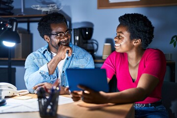 Poster - African american man and woman business workers using touchpad working at office