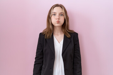 Poster - Young caucasian business woman wearing black jacket puffing cheeks with funny face. mouth inflated with air, crazy expression.