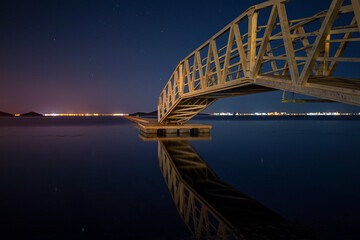 Wall Mural - Iron bridge and wooden walkway over the Mar Menor, Cartagena, Spain, at dusk