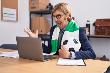 Poster - Caucasian man with mustache working at the office supporting football team celebrating victory with happy smile and winner expression with raised hands