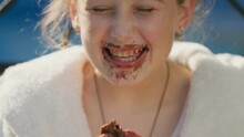 Portrait Of A Girl Who Eats Chocolate Ice Cream And Gets Dirty
