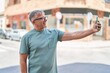 © Krakenimages.com - Middle age grey-haired man smiling confident making selfie by the smartphone at street