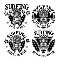 Wall Mural - Surfing set of vector emblems, badges, labels, stickers or logos with tiki head and surfboards. Illustration in vintage monochrome style isolated on white background