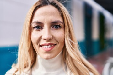 Sticker - Young blonde woman smiling confident standing at street