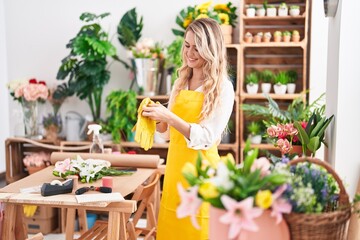 Sticker - Young blonde woman florist smiling confident wearing gloves at florist