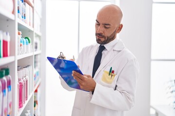 Sticker - Young bald man pharmacist writing on document at pharmacy